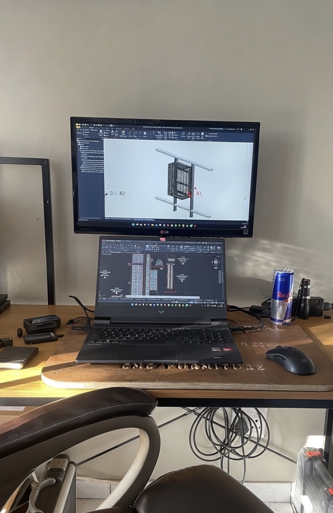 Engineer working at a desk on CAD design software